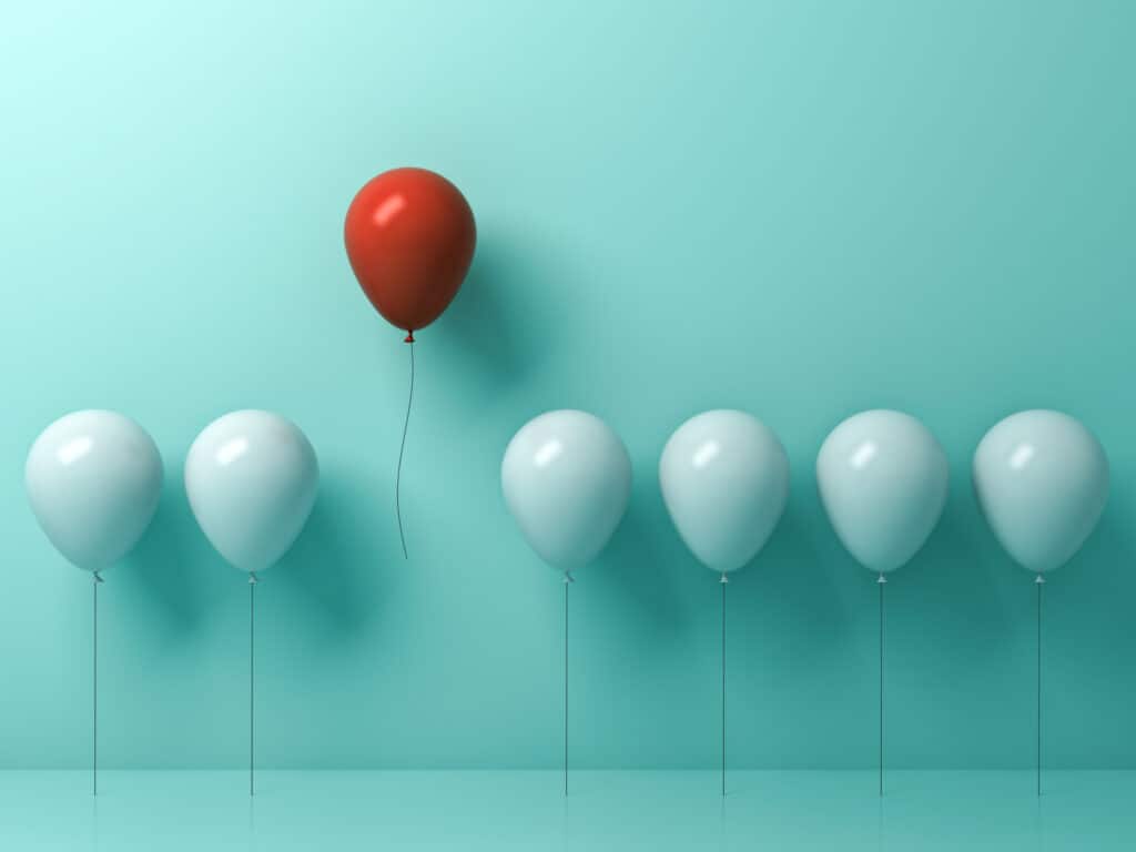Stand out from the crowd and different concept , One red balloon flying away from other white balloons on light green pastel color wall background with reflections and shadows . 3D rendering.