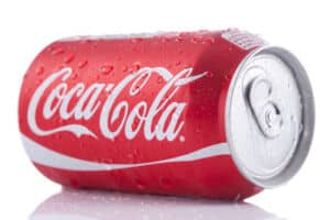 A can of Coca-Cola straight out of the fridge, still drenched in condensation, shot in the studio and isolated on a white background. Coca-Cola was invented in the 1880s and is one of the world's best selling drinks."