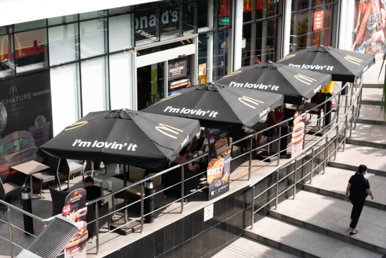 Logo and slogan of McDonald's fast food restaurant on the patio umbrella.